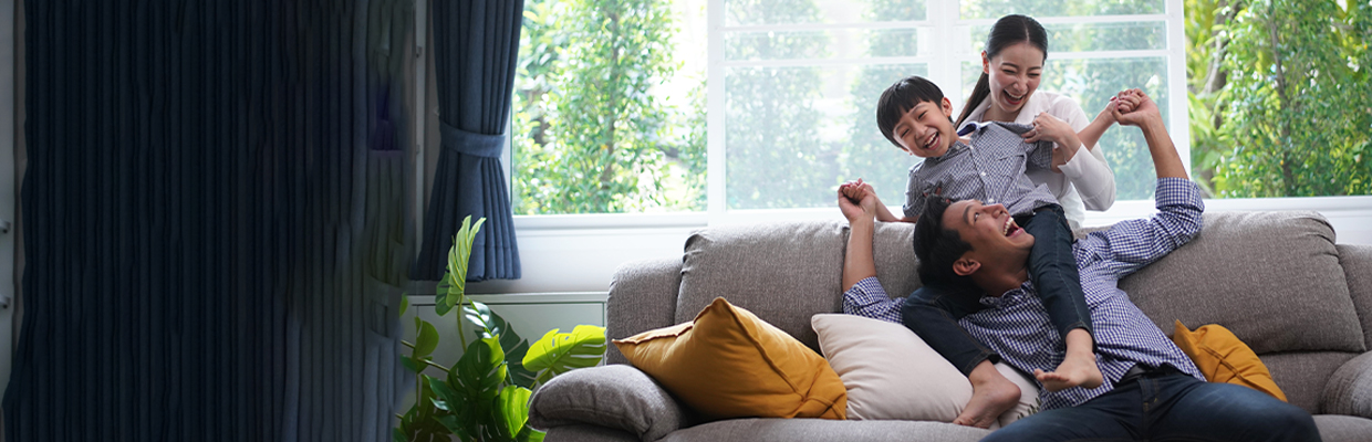 Boy and parents on sofa; image used for HSBC Vietnam Home insurance page