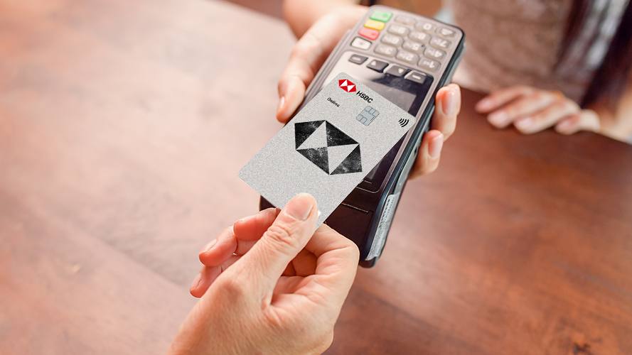 a man making a payment on a POS machine with an HSBC card