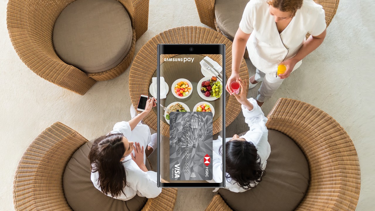 two women enjoying a healthy meal in a restaurant and a phone with samsung pay feature; image used for HSBC Vietnam Samsung pay page