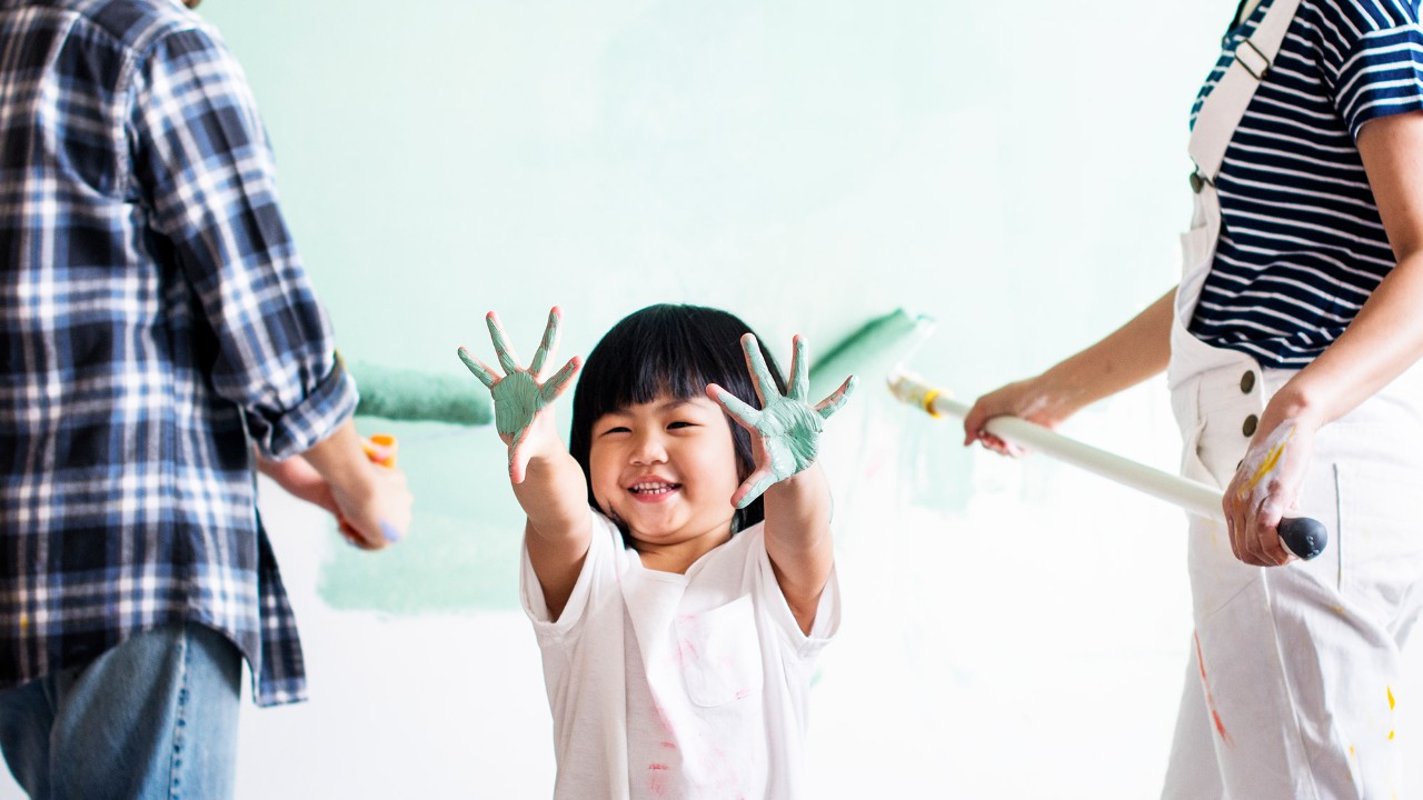 Son and parents painting a room; image used for HSBC Vietnam Home Equity Loan page