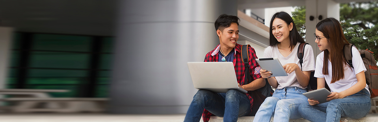 Three students using tablets and laptop on campus; image used for HSBC Vietnam International Student Program page