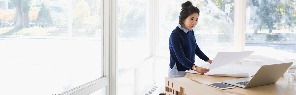 Asian woman looking at charts; image used for HSBC Vietnam Financial Planning page.