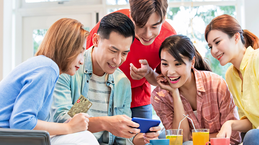 A group of young people playing mobile games