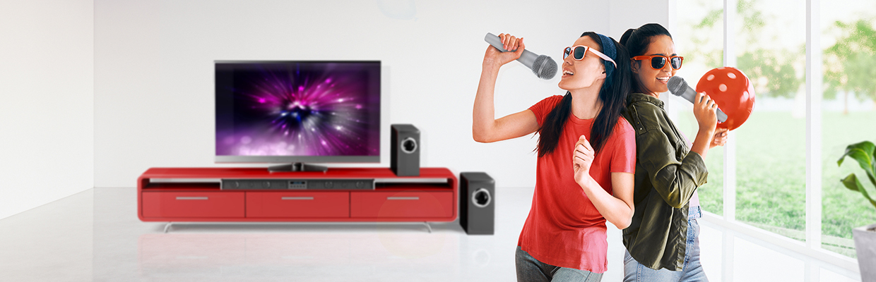 two women are singing karaoke at home; image used for HSBC VN Personal Instalment Loan page.